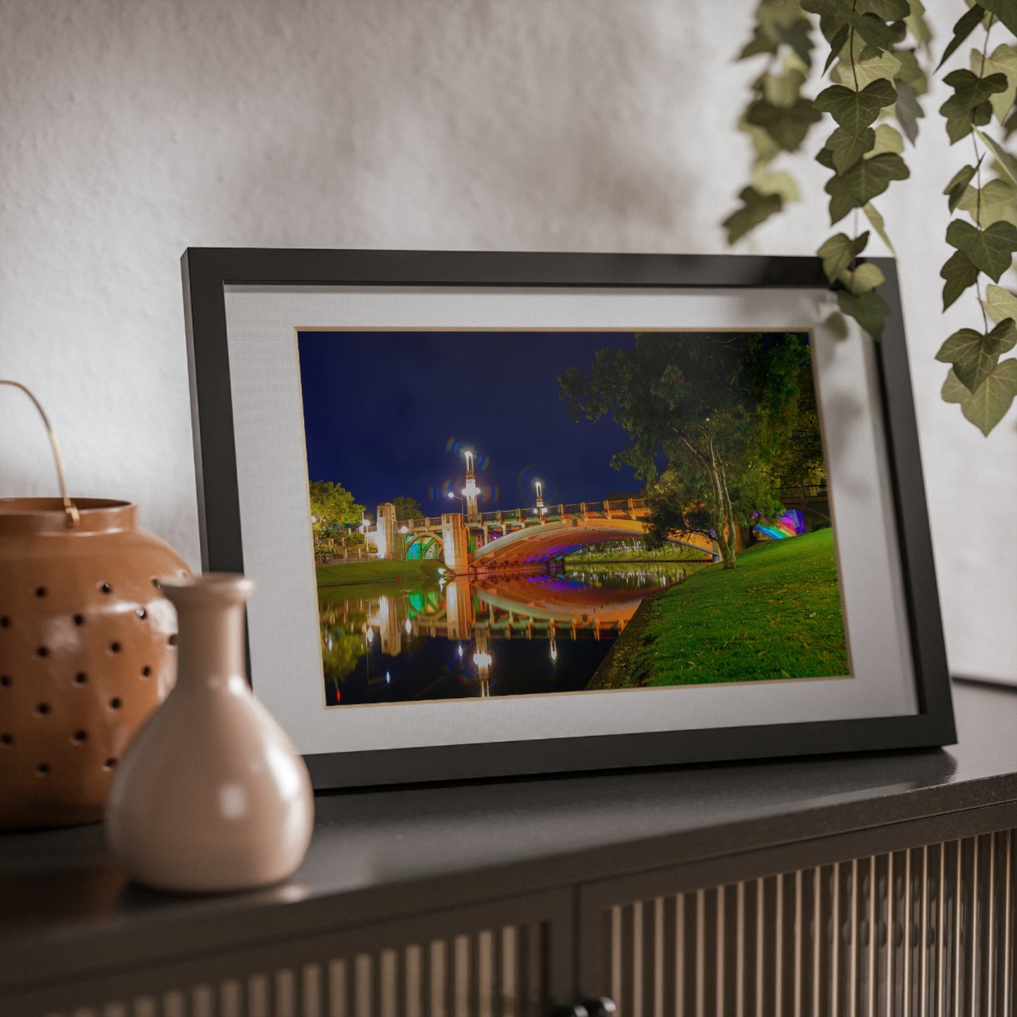 The stunning Victoria Bridge brightly lit at night printed on a black framed poster