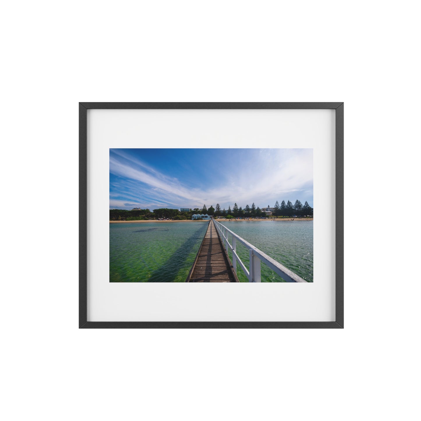 A beautiful jetty leading towards the shore over turquoise waters printed on a matte framed poster