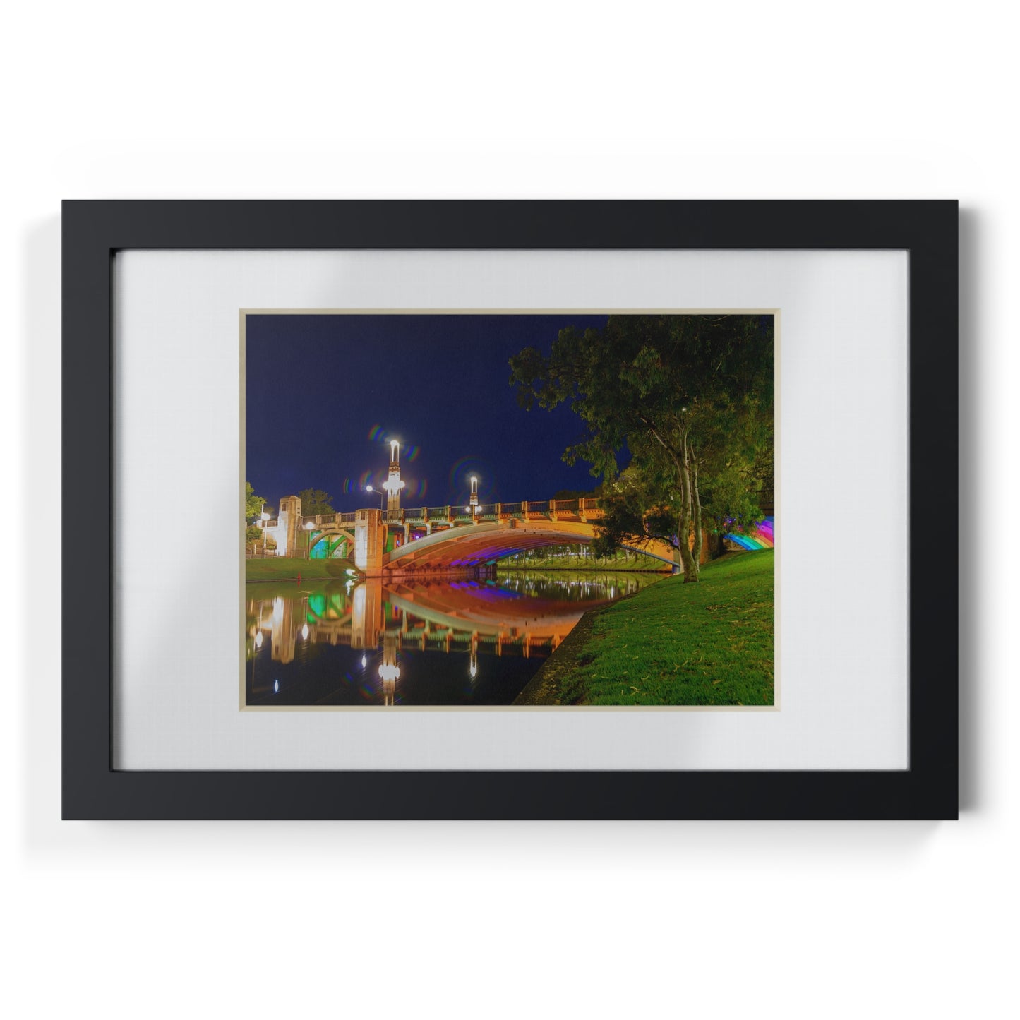 The stunning Victoria Bridge brightly lit at night printed on a black framed poster