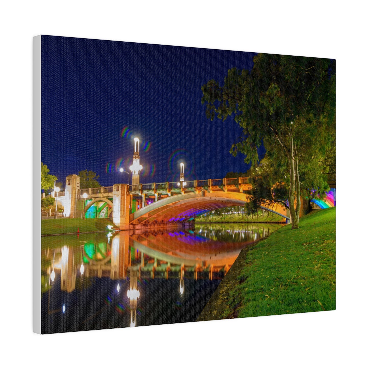 The stunning Victoria Bridge brightly lit at night printed on a stretched matte canvas