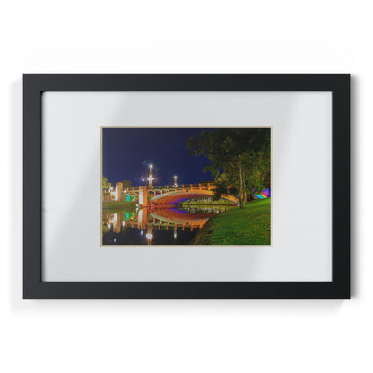 The stunning Victoria Bridge brightly lit at night printed on a black framed poster