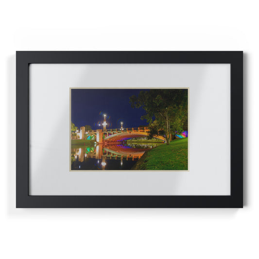 The stunning Victoria Bridge brightly lit at night printed on a black framed poster