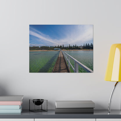 A beautiful jetty leading towards the shore over turquoise waters printed on a stretched matte canvas