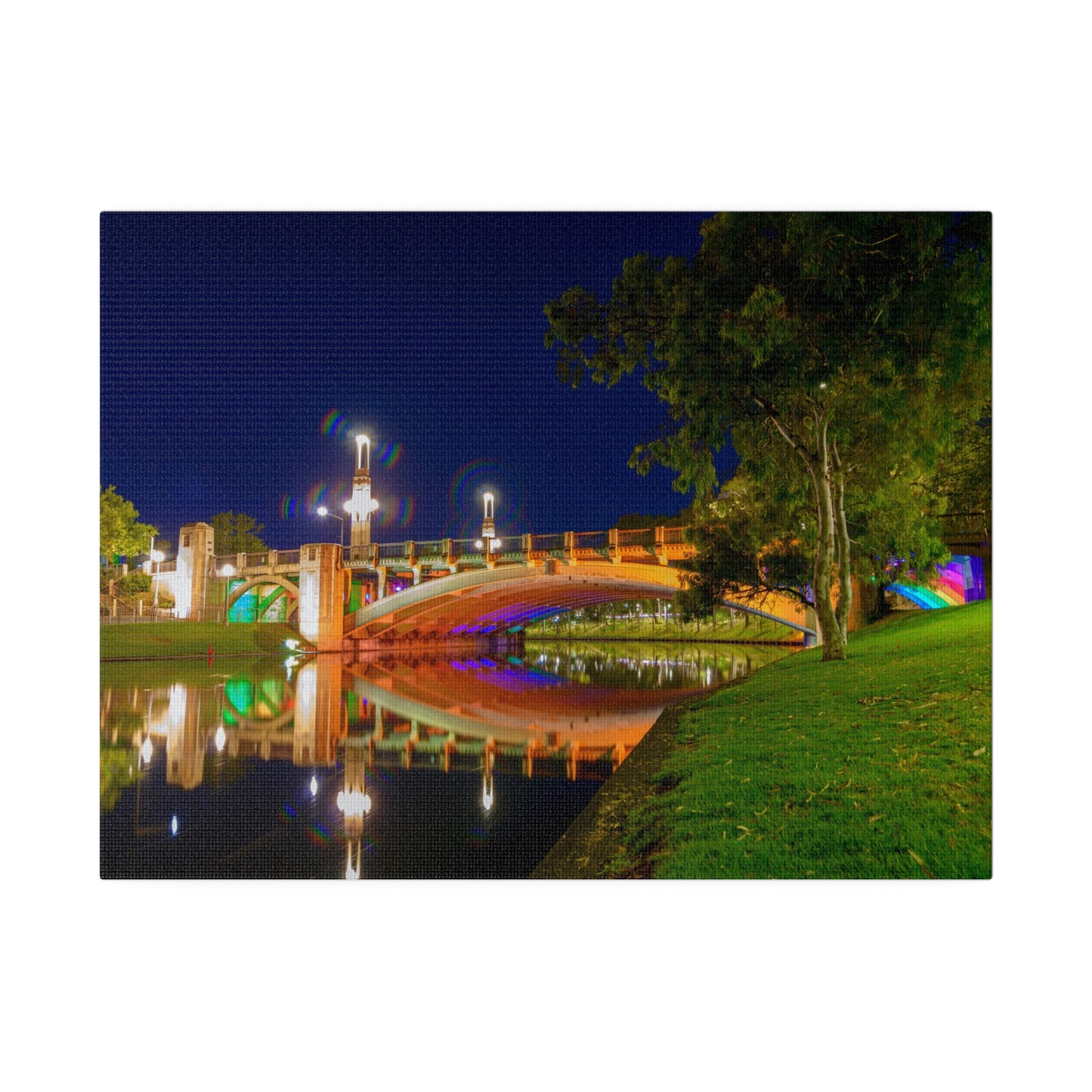 The stunning Victoria Bridge brightly lit at night printed on a stretched matte canvas