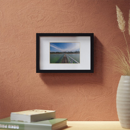 A beautiful jetty leading towards the shore over turquoise waters printed on a black framed poster