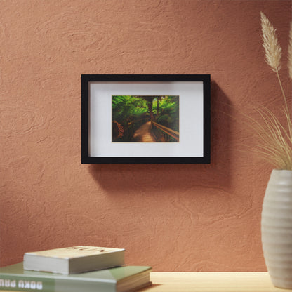 Wooden bridge winding through a lush forest of tall ferns printed black framed poster