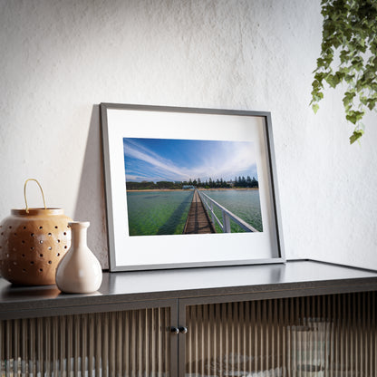 A beautiful jetty leading towards the shore over turquoise waters printed on a matte framed poster