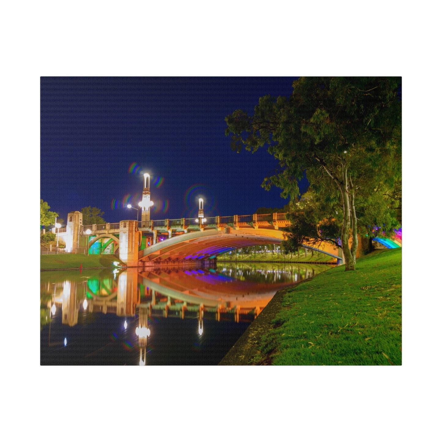 The stunning Victoria Bridge brightly lit at night printed on a stretched matte canvas