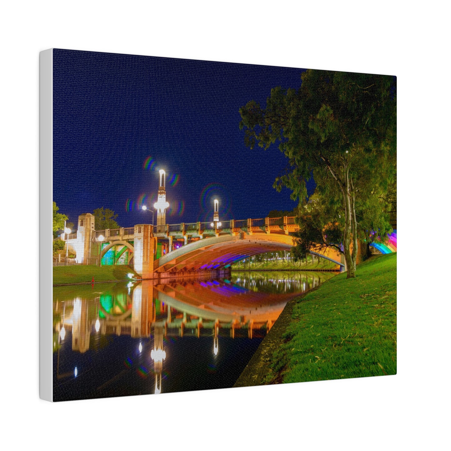 The stunning Victoria Bridge brightly lit at night printed on a stretched matte canvas