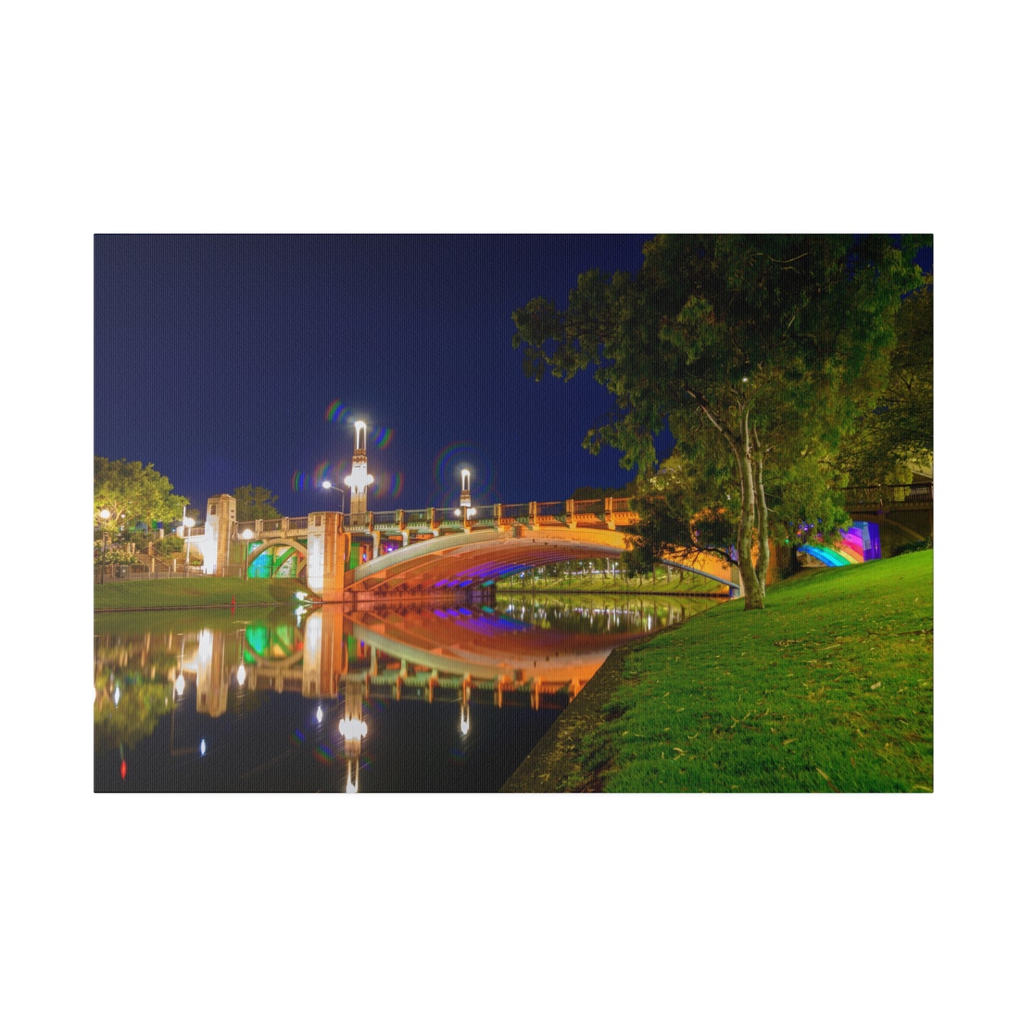 The stunning Victoria Bridge brightly lit at night printed on a stretched matte canvas