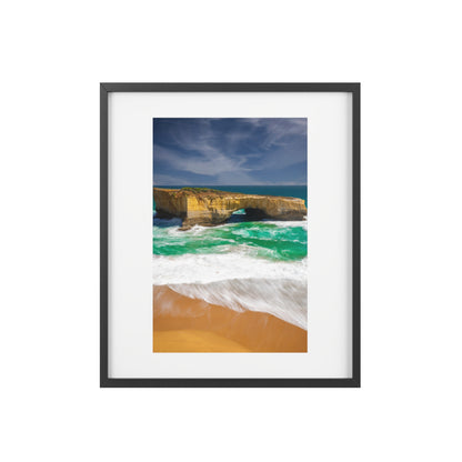 The London Bridge arch with crashing waves printed on a matte framed poster