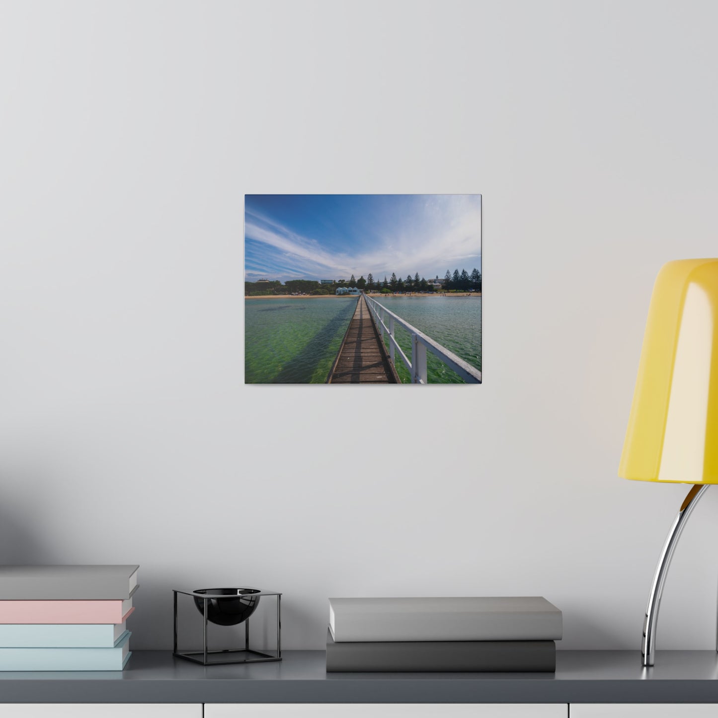 A beautiful jetty leading towards the shore over turquoise waters printed on a stretched matte canvas