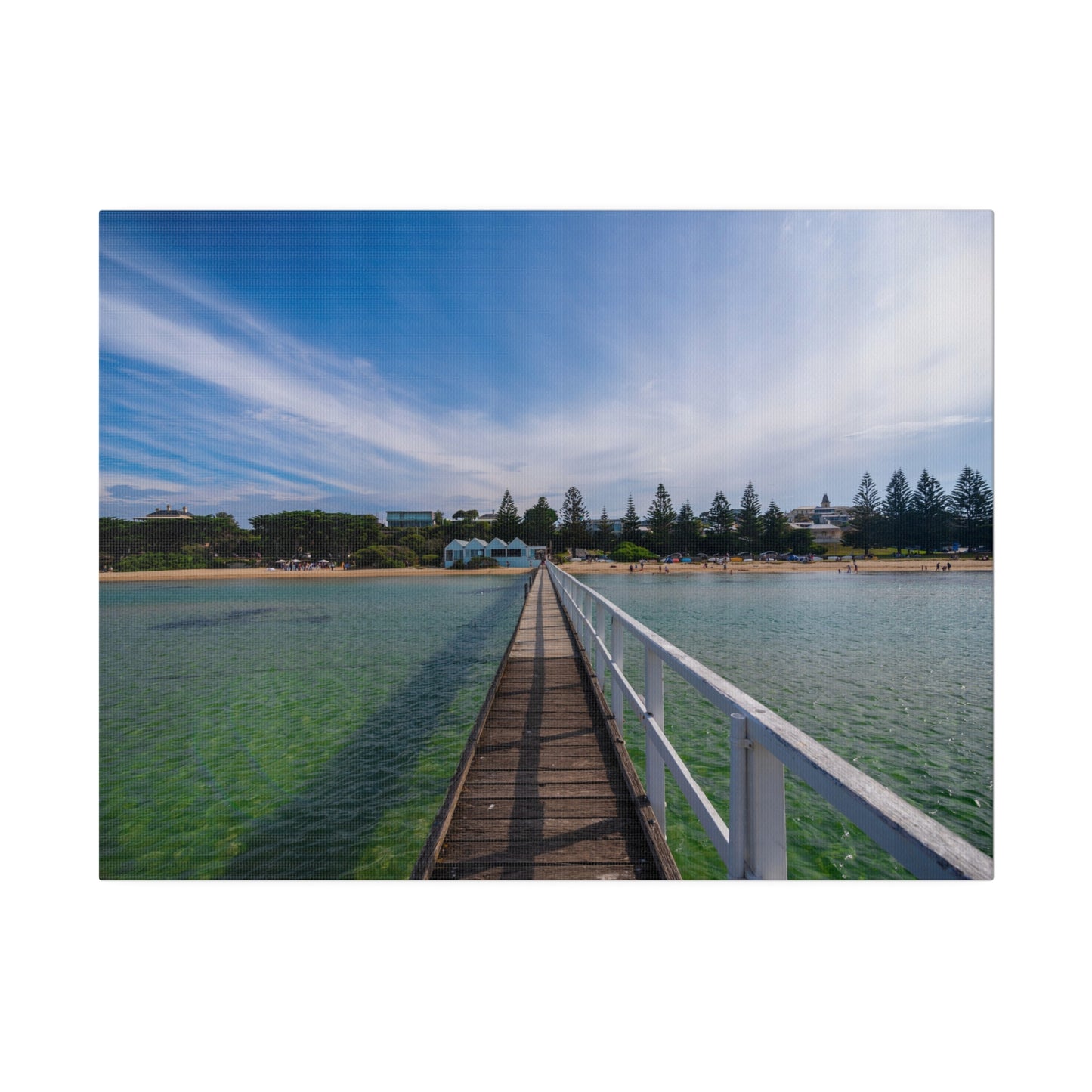 A beautiful jetty leading towards the shore over turquoise waters printed on a stretched matte canvas