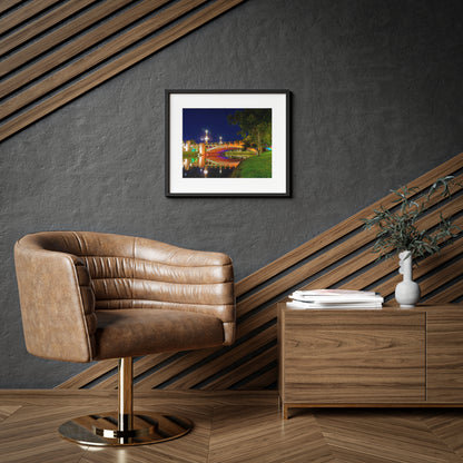 The stunning Victoria Bridge brightly lit at night printed on a framed matte poster