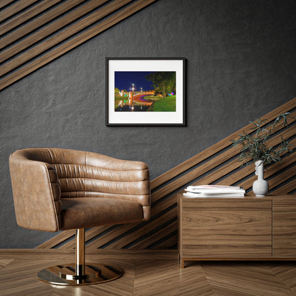 The stunning Victoria Bridge brightly lit at night printed on a framed matte poster