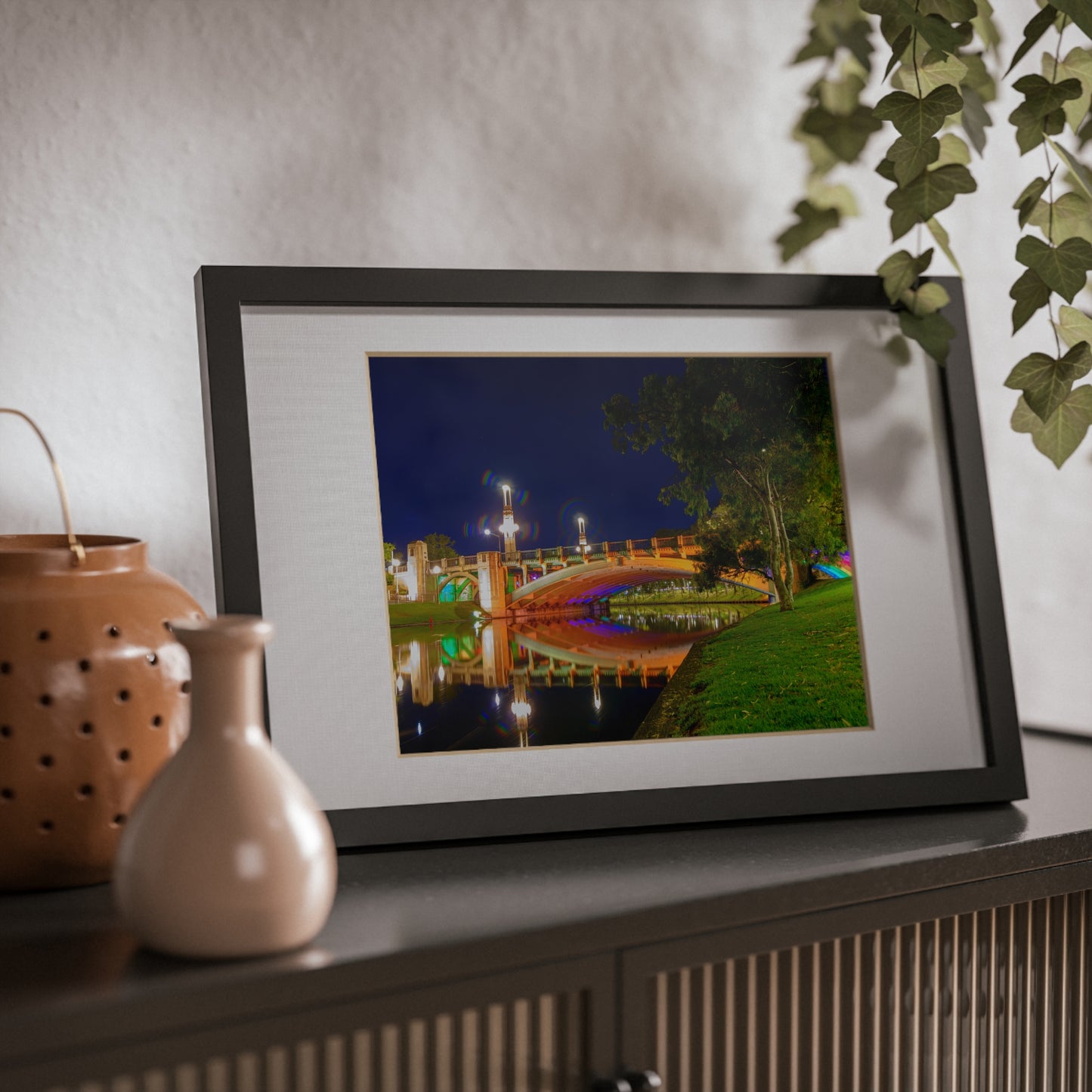 The stunning Victoria Bridge brightly lit at night printed on a black framed poster