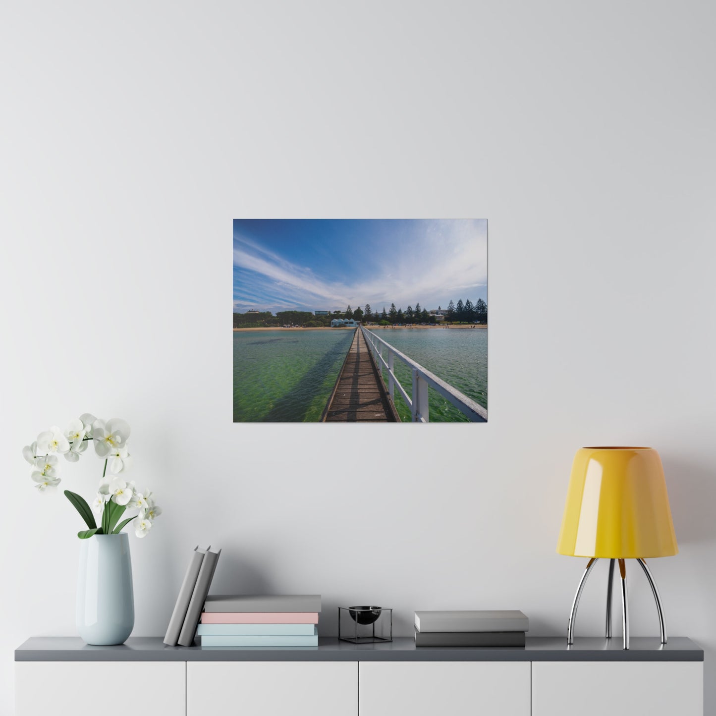 A beautiful jetty leading towards the shore over turquoise waters printed on a stretched matte canvas