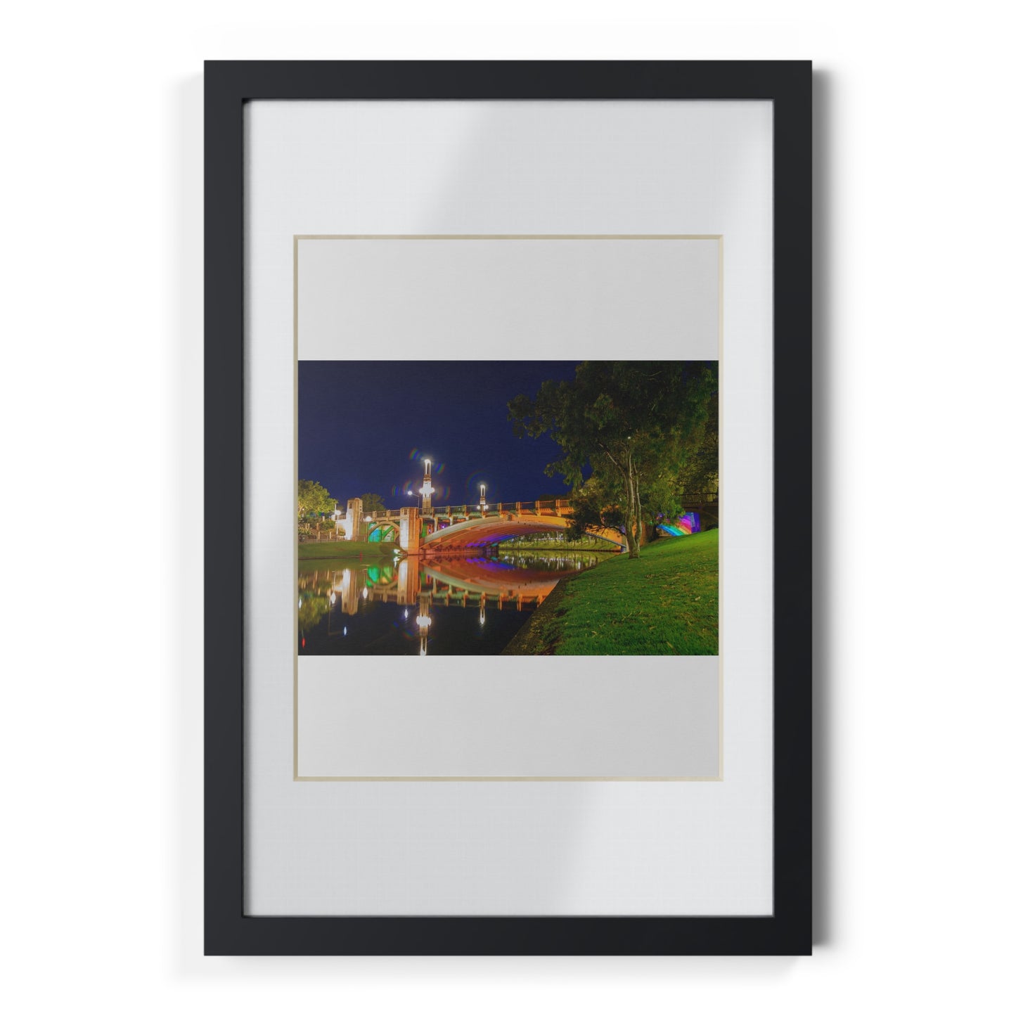 The stunning Victoria Bridge brightly lit at night printed on a black framed poster