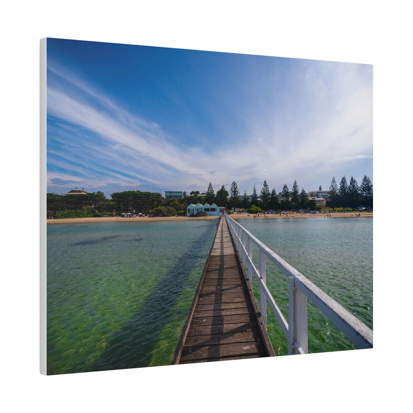 A beautiful jetty leading towards the shore over turquoise waters printed on a stretched matte canvas