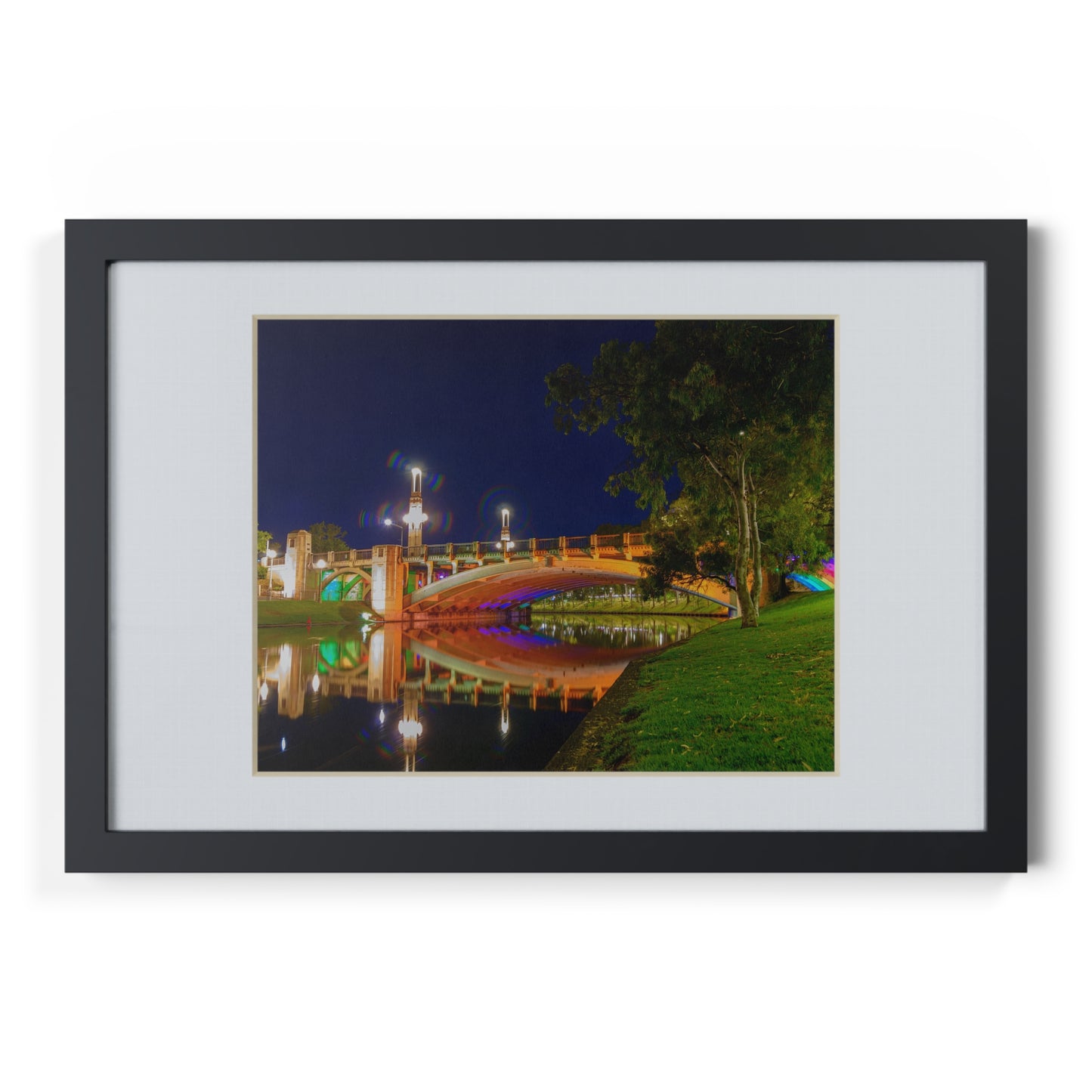 The stunning Victoria Bridge brightly lit at night printed on a black framed poster