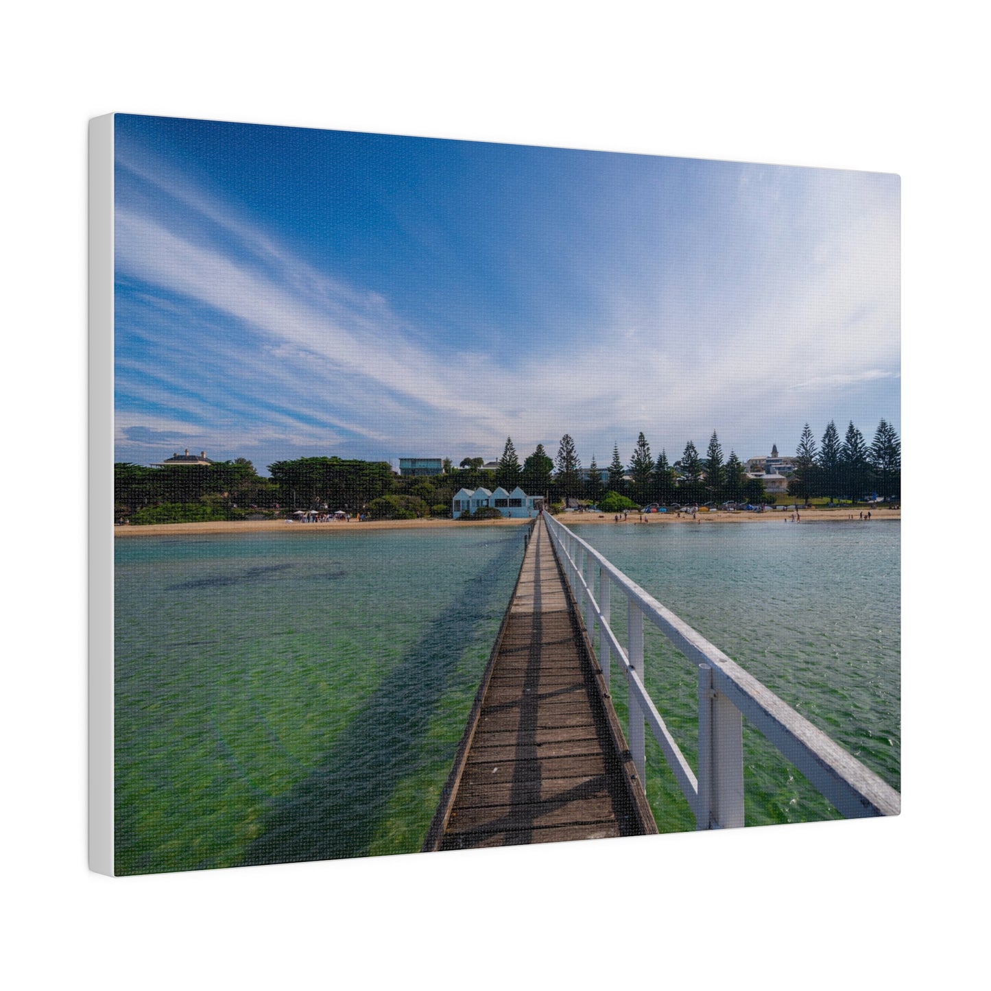 A beautiful jetty leading towards the shore over turquoise waters printed on a stretched matte canvas