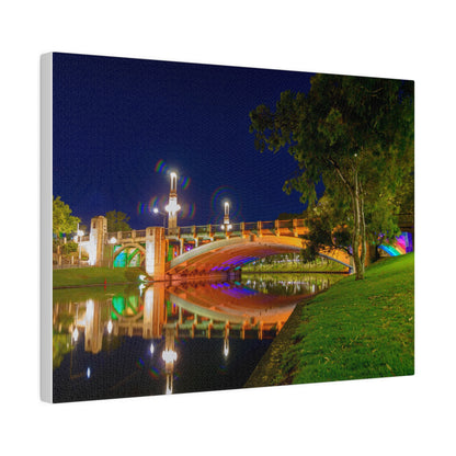 The stunning Victoria Bridge brightly lit at night printed on a stretched matte canvas