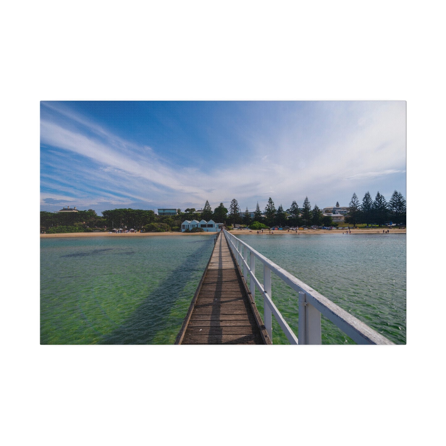 A beautiful jetty leading towards the shore over turquoise waters printed on a stretched matte canvas