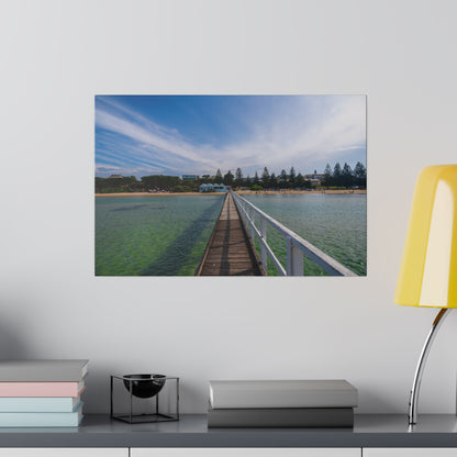 A beautiful jetty leading towards the shore over turquoise waters printed on a stretched matte canvas