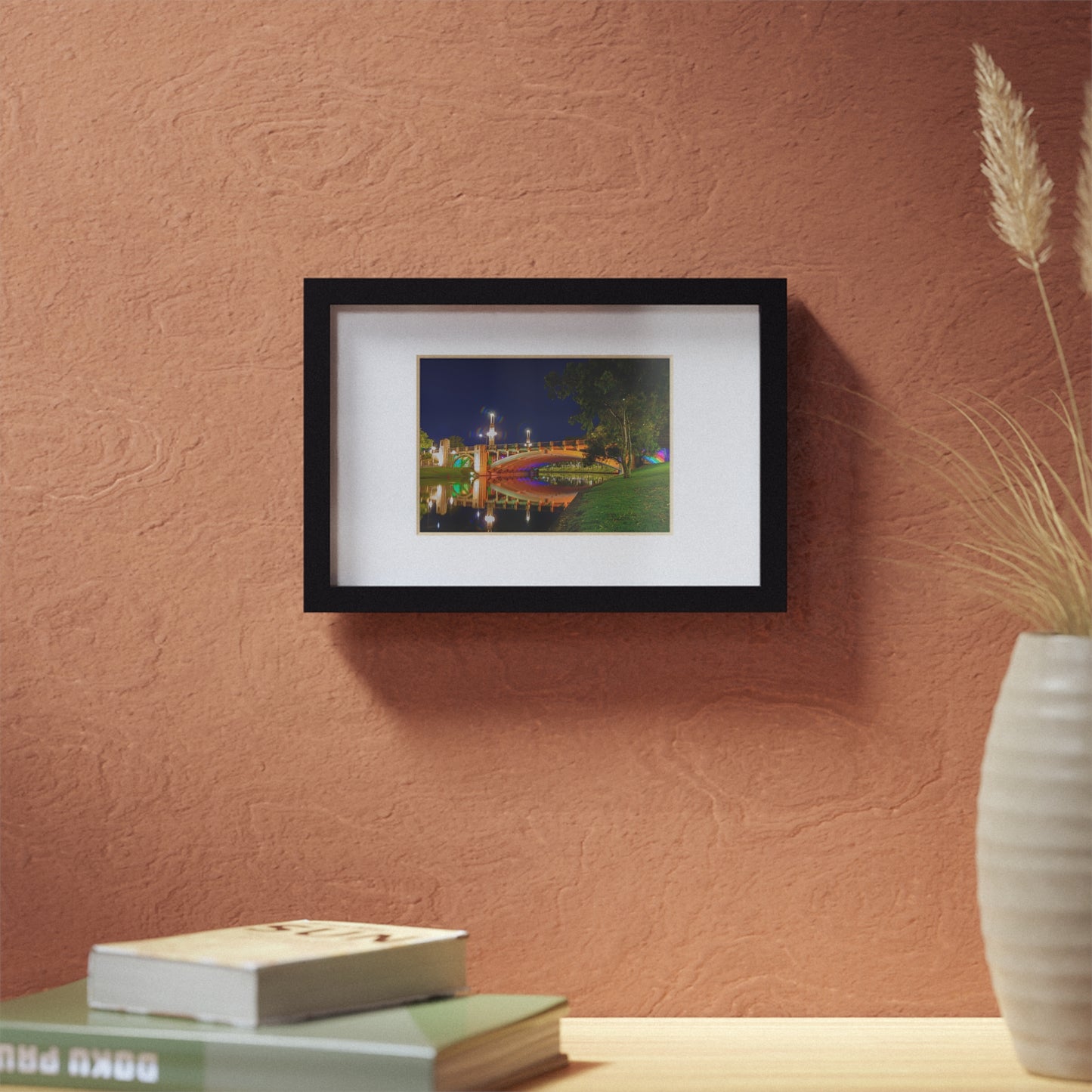 The stunning Victoria Bridge brightly lit at night printed on a black framed poster