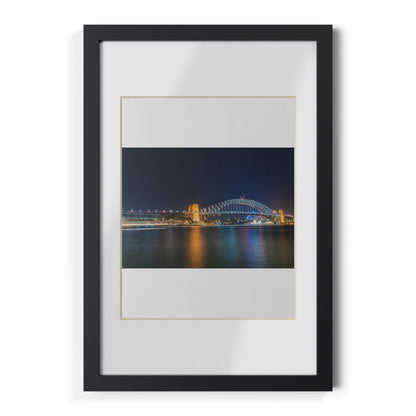 The dazzling Sydney Harbour Bridge at night printed on a black framed poster