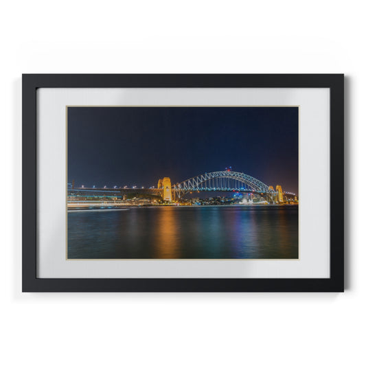 The dazzling Sydney Harbour Bridge at night printed on a black framed poster