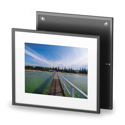 A beautiful jetty leading towards the shore over turquoise waters printed on a matte framed poster