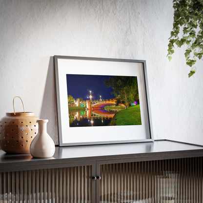 The stunning Victoria Bridge brightly lit at night printed on a framed matte poster