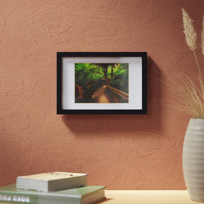 Wooden bridge winding through a lush forest of tall ferns printed black framed poster