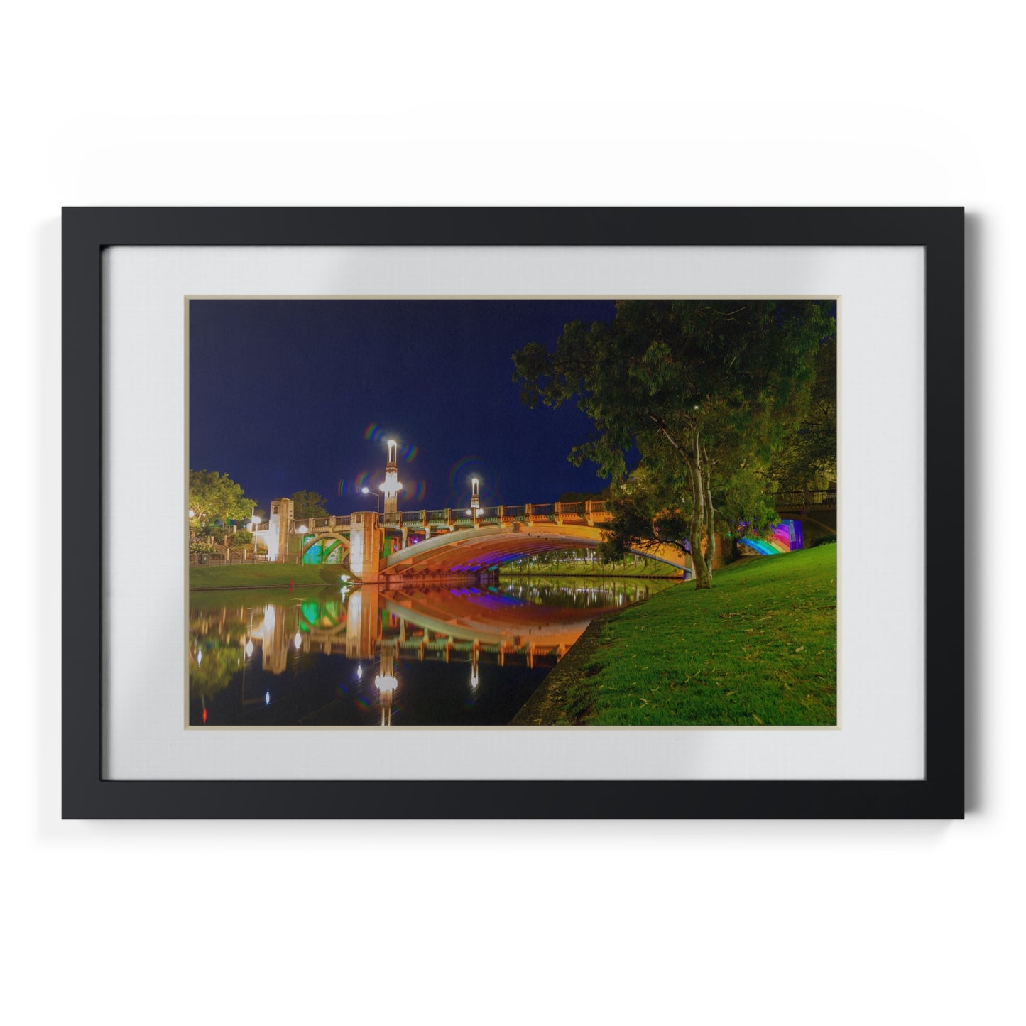 The stunning Victoria Bridge brightly lit at night printed on a black framed poster