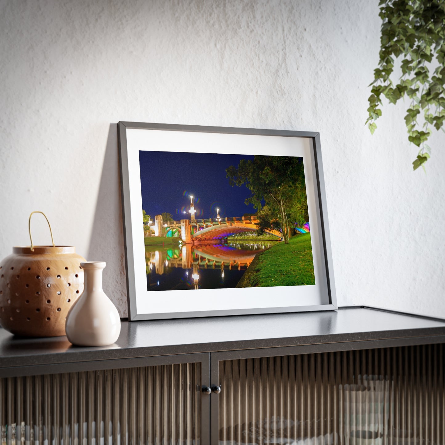 The stunning Victoria Bridge brightly lit at night printed on a framed matte poster