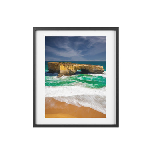 The London Bridge arch with crashing waves printed on a matte framed poster