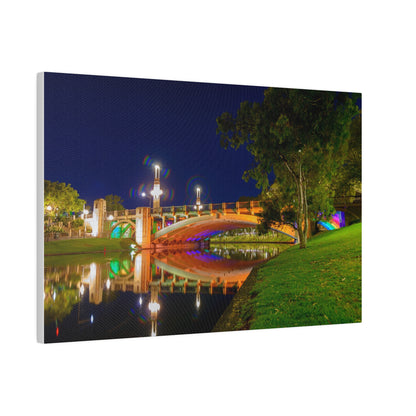 The stunning Victoria Bridge brightly lit at night printed on a stretched matte canvas