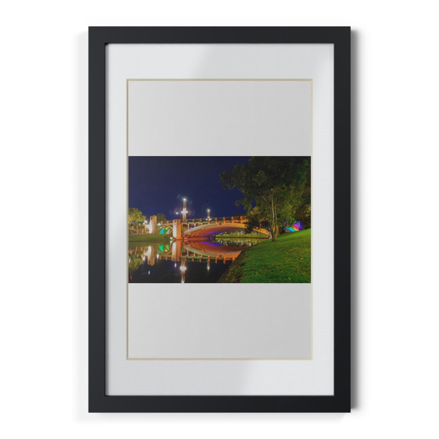 The stunning Victoria Bridge brightly lit at night printed on a black framed poster