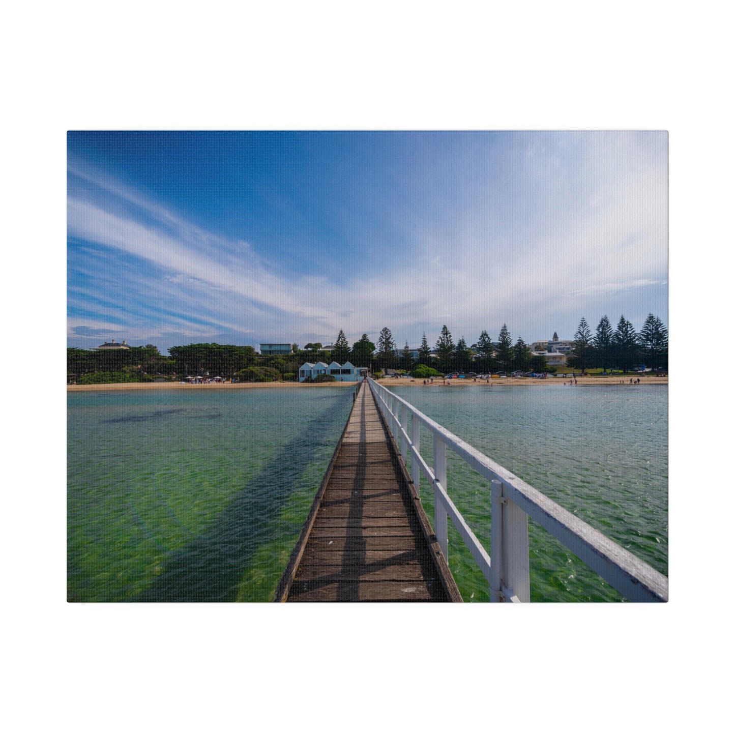 A beautiful jetty leading towards the shore over turquoise waters printed on a stretched matte canvas