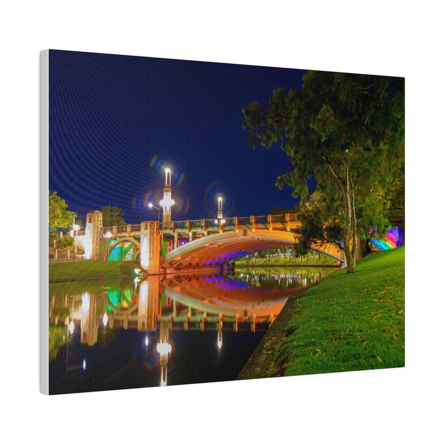 The stunning Victoria Bridge brightly lit at night printed on a stretched matte canvas