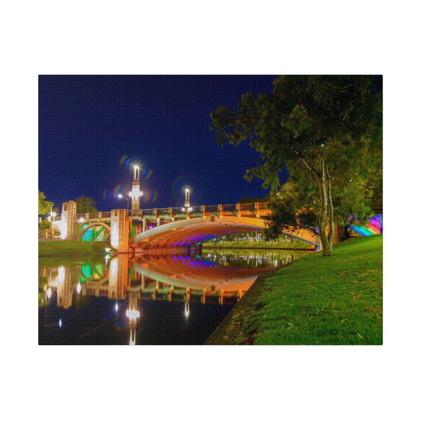 The stunning Victoria Bridge brightly lit at night printed on a stretched matte canvas